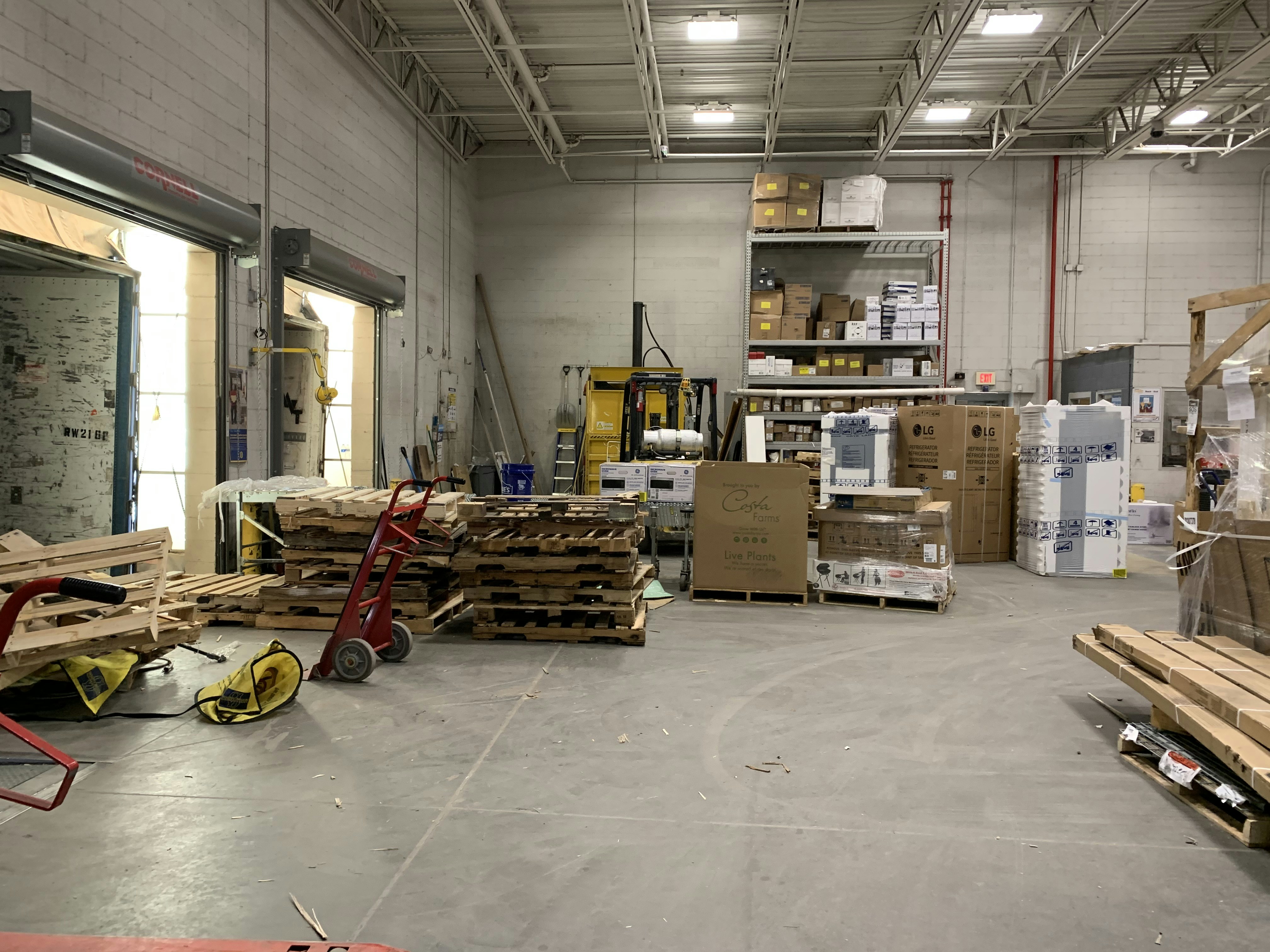 Warehouse interior with stacked cargo boxes and pallets, warm industrial lighting